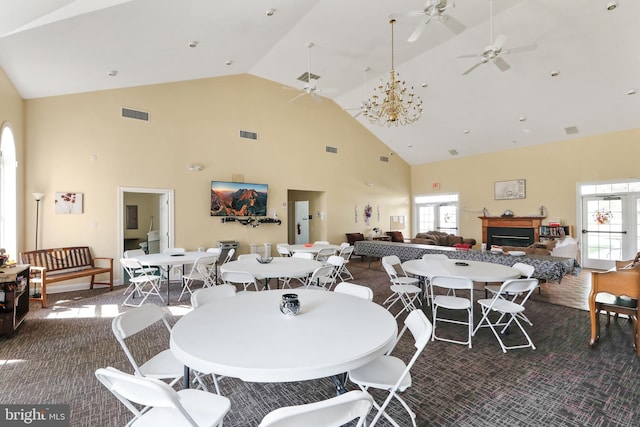 dining space with high vaulted ceiling, a healthy amount of sunlight, and ceiling fan