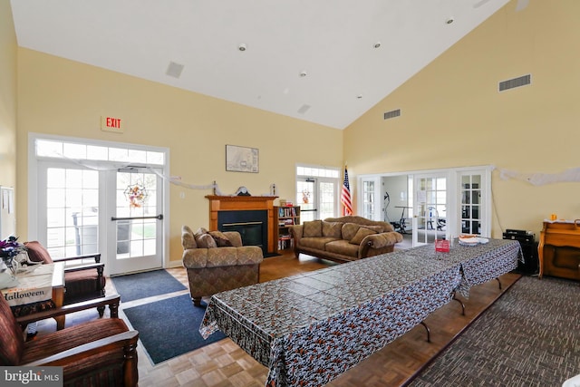 living room with french doors and high vaulted ceiling