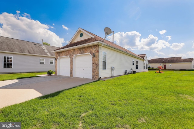 view of side of home featuring a garage and a yard