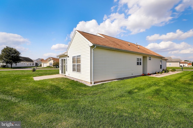 view of home's exterior with a yard