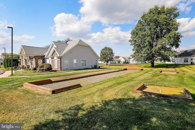 exterior space with cooling unit and a lawn