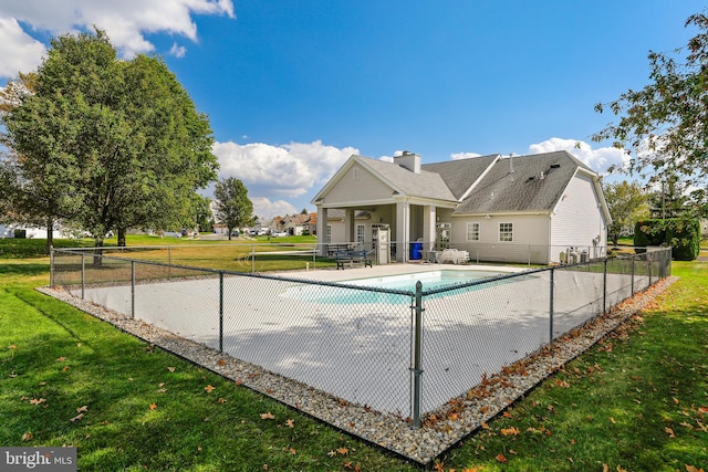 view of pool with a patio area and a lawn