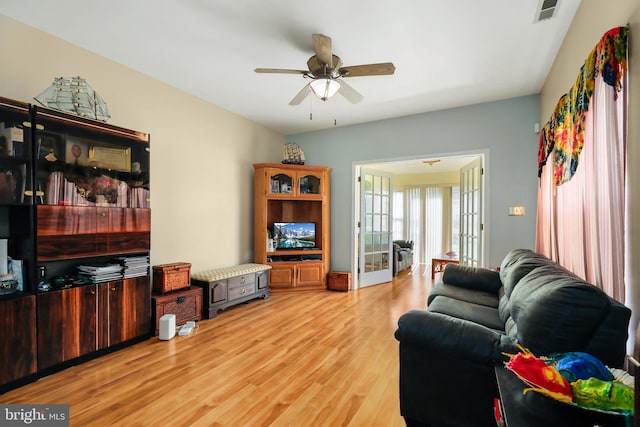 living room with french doors, light hardwood / wood-style flooring, and ceiling fan