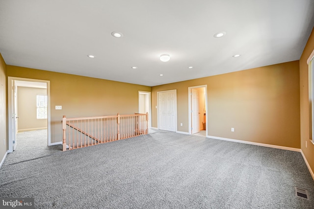 unfurnished room featuring light carpet