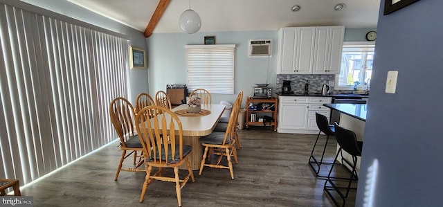 dining space featuring beam ceiling, dark wood-type flooring, and a wall mounted air conditioner