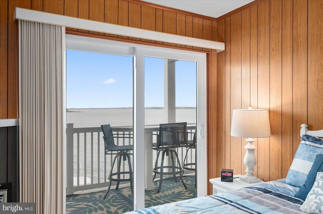 bedroom with a water view and wooden walls