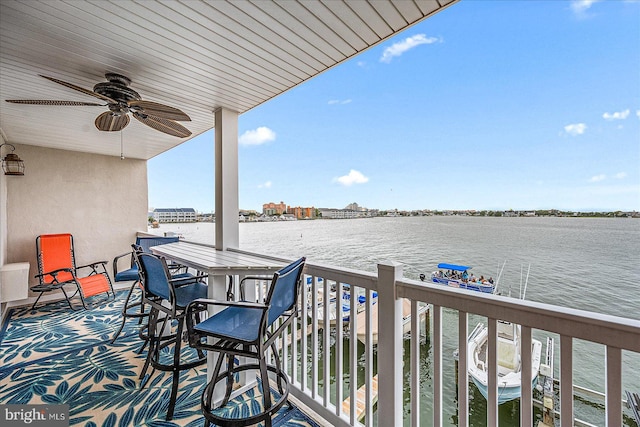 balcony featuring a water view and ceiling fan