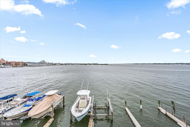 dock area with a water view and boat lift