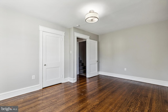 unfurnished bedroom featuring dark wood-type flooring