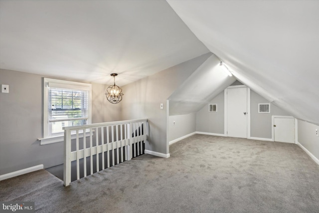 additional living space with carpet, vaulted ceiling, and a chandelier