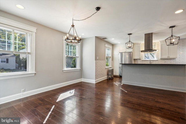 interior space with radiator, dark hardwood / wood-style floors, and plenty of natural light