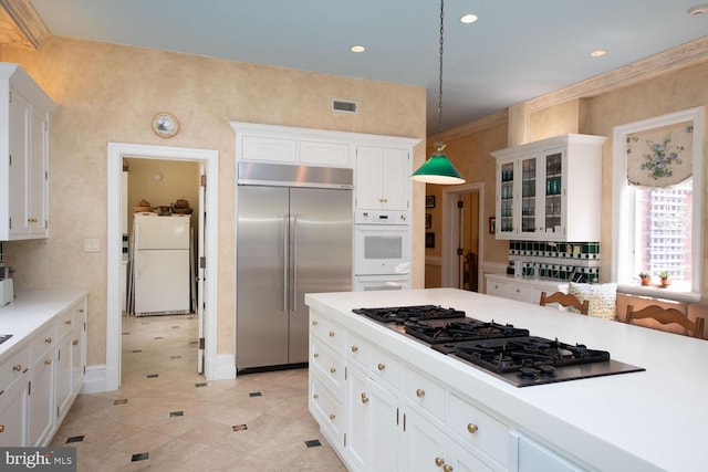 kitchen with visible vents, white cabinetry, white appliances, light countertops, and glass insert cabinets