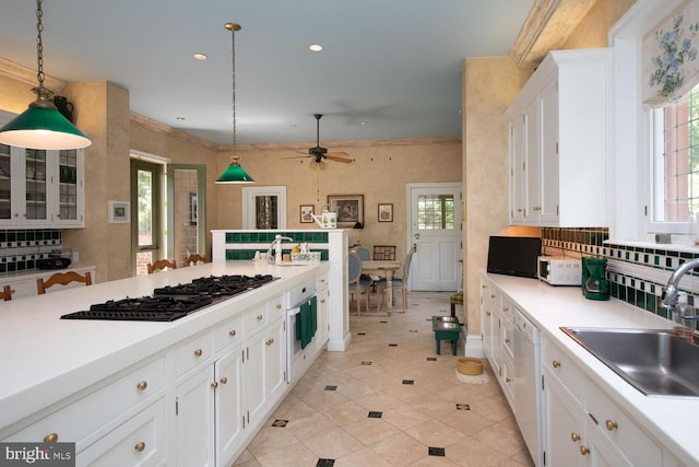 kitchen featuring a sink, black gas cooktop, white cabinets, white dishwasher, and light countertops