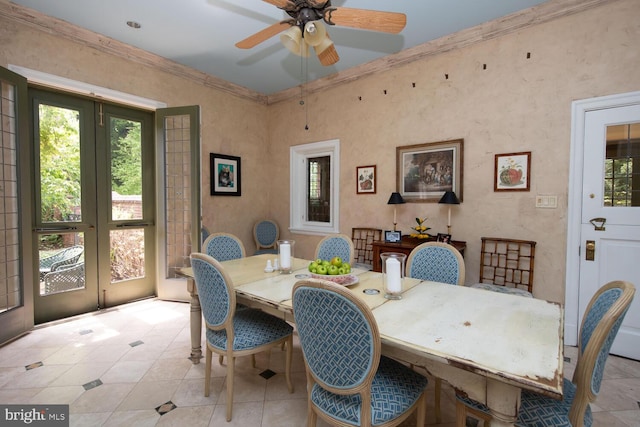 dining room with light tile patterned floors, crown molding, and a ceiling fan