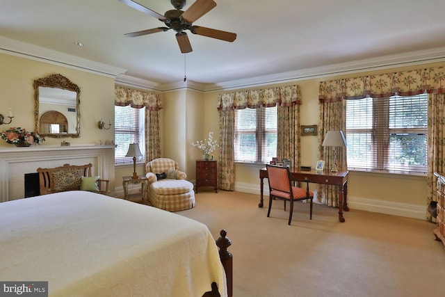 carpeted bedroom with a ceiling fan, baseboards, and ornamental molding