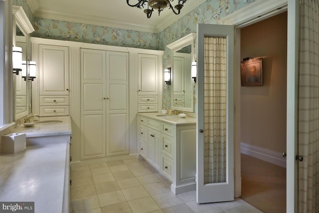 bathroom with tile patterned flooring, wallpapered walls, baseboards, ornamental molding, and vanity