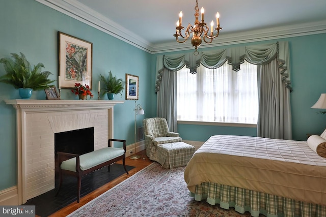 bedroom with visible vents, wood finished floors, a fireplace, crown molding, and baseboards