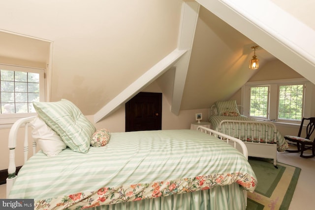 bedroom with lofted ceiling and carpet