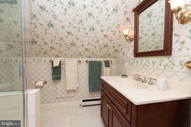 bathroom with vanity, wallpapered walls, and a baseboard heating unit