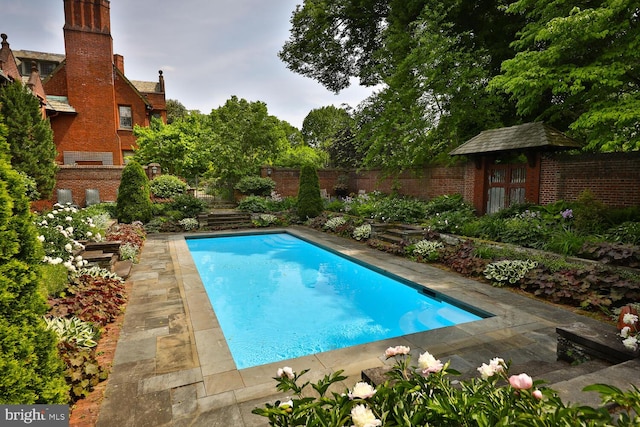 view of swimming pool featuring a fenced in pool and a fenced backyard