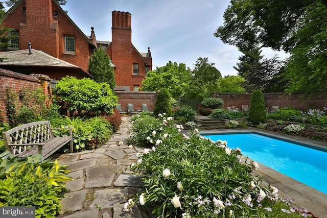 view of swimming pool featuring a fenced backyard and a fenced in pool