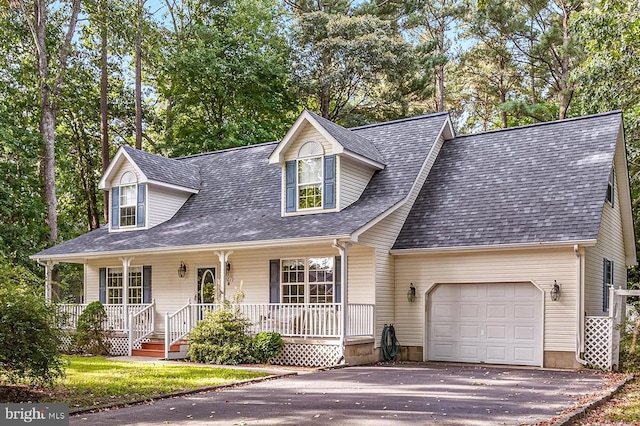 cape cod-style house with covered porch and a garage