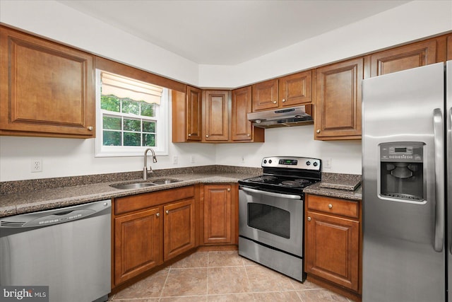 kitchen featuring appliances with stainless steel finishes, light tile patterned floors, and sink