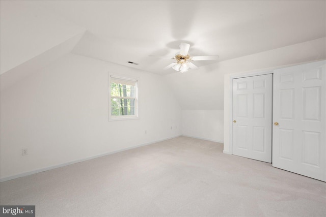 interior space featuring light colored carpet, lofted ceiling, and ceiling fan