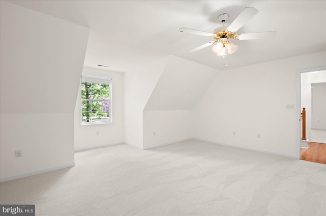 bonus room with ceiling fan, light carpet, and vaulted ceiling