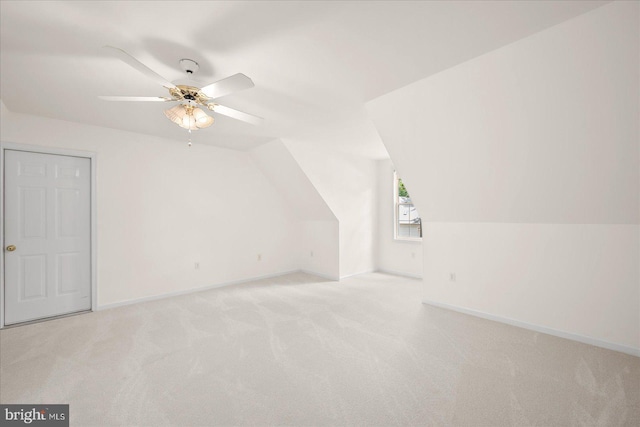 bonus room featuring ceiling fan, light carpet, and vaulted ceiling