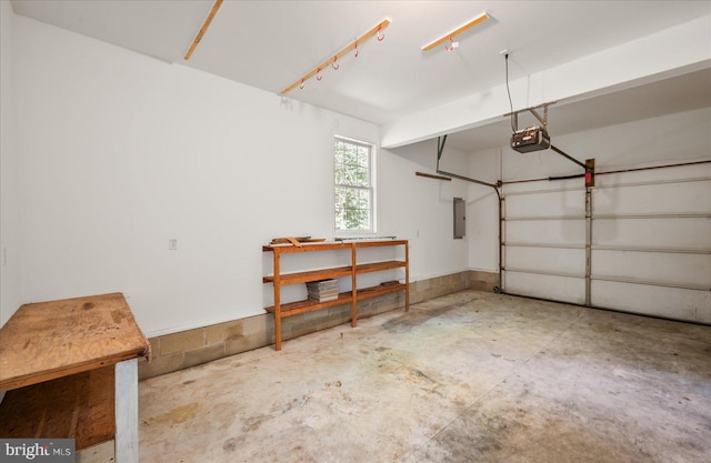 garage with a garage door opener and electric panel