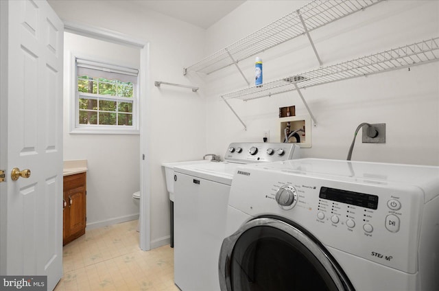 clothes washing area featuring separate washer and dryer