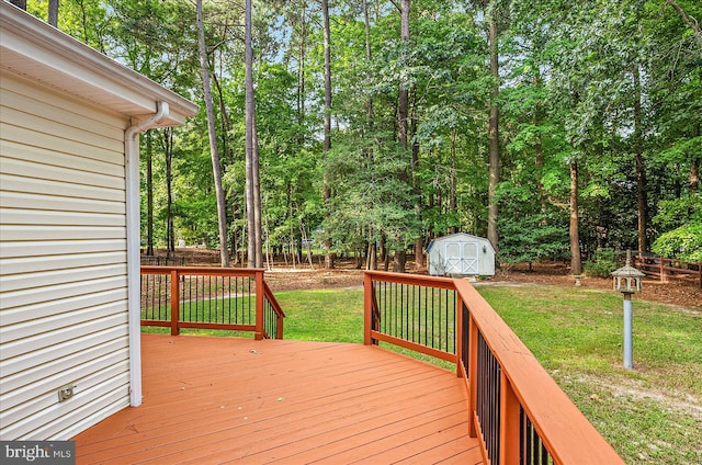 wooden terrace with a lawn and a shed