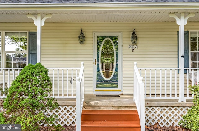 entrance to property featuring a porch