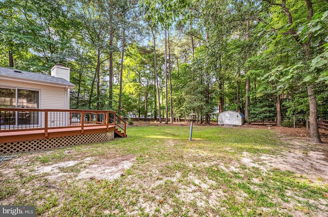 view of yard with a storage shed and a deck