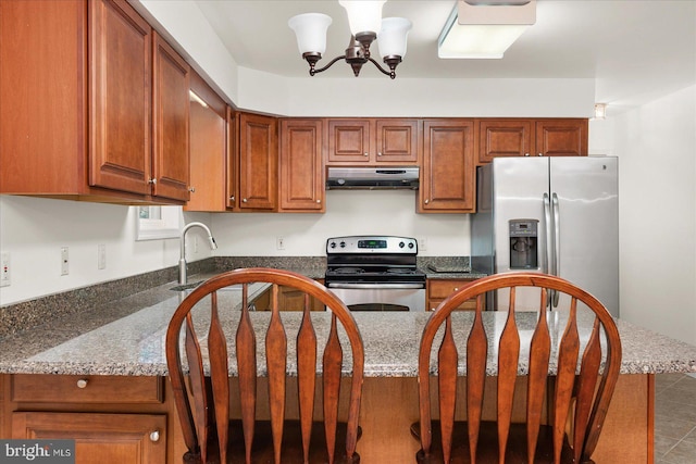 kitchen featuring tile patterned flooring, stainless steel appliances, sink, and dark stone counters