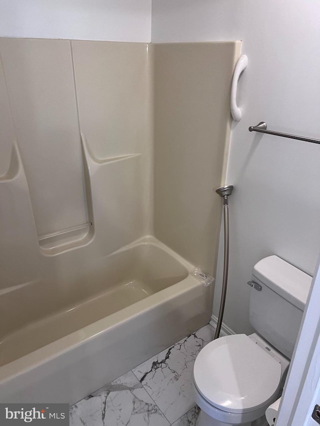 full bathroom featuring toilet, marble finish floor, and washtub / shower combination