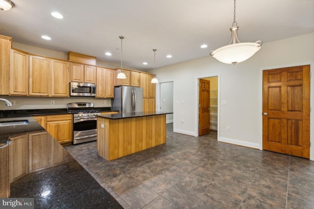 kitchen featuring appliances with stainless steel finishes, hanging light fixtures, a kitchen island, and sink