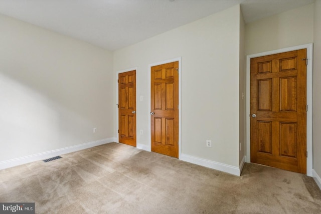 unfurnished bedroom with light colored carpet