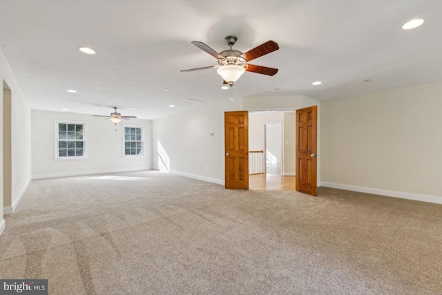 unfurnished living room featuring light carpet and ceiling fan