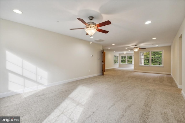 unfurnished living room with light carpet and ceiling fan