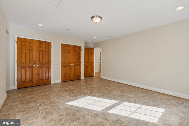 unfurnished bedroom with two closets