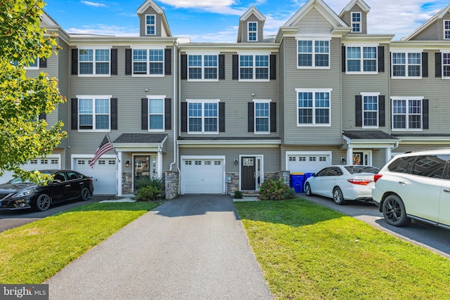 townhome / multi-family property with a garage and a front lawn