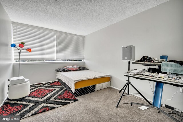 bedroom featuring light colored carpet and a textured ceiling