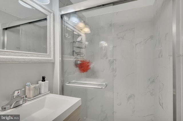 bathroom featuring vanity and a shower with shower door