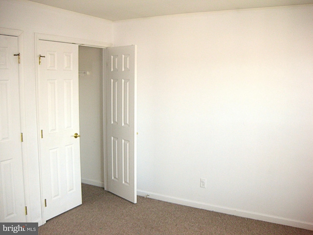 unfurnished bedroom with a closet and carpet