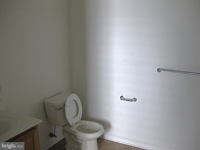 bathroom featuring tile patterned floors, vanity, and toilet