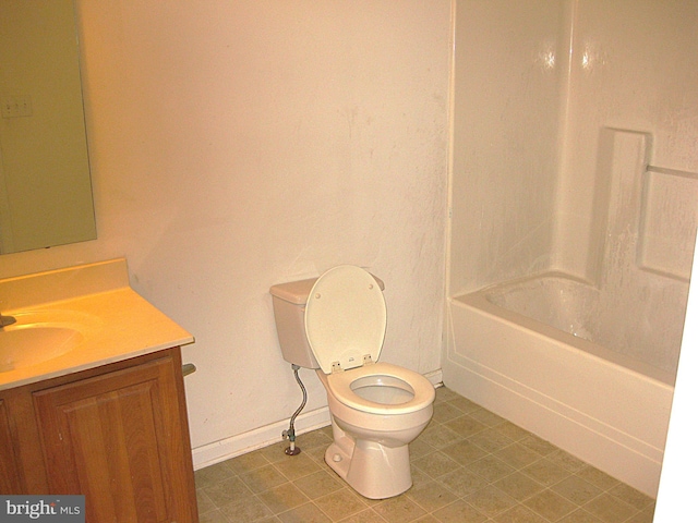 full bathroom featuring washtub / shower combination, tile patterned flooring, vanity, and toilet