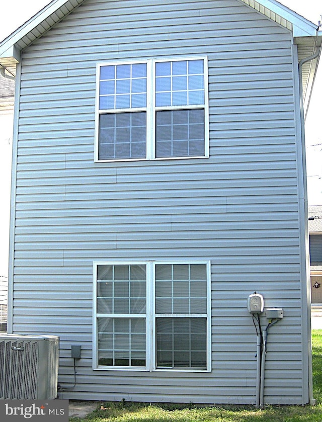 view of side of home featuring central AC unit