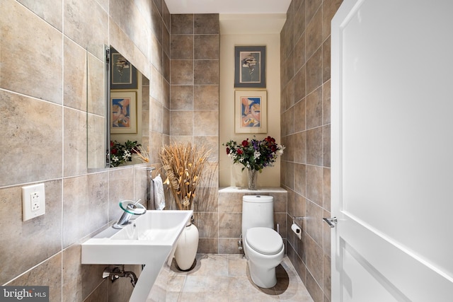 bathroom featuring tile walls, toilet, and tile patterned floors